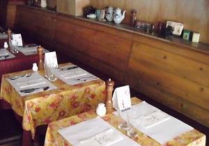 Inside picture of restaurant with tables ready for customers.